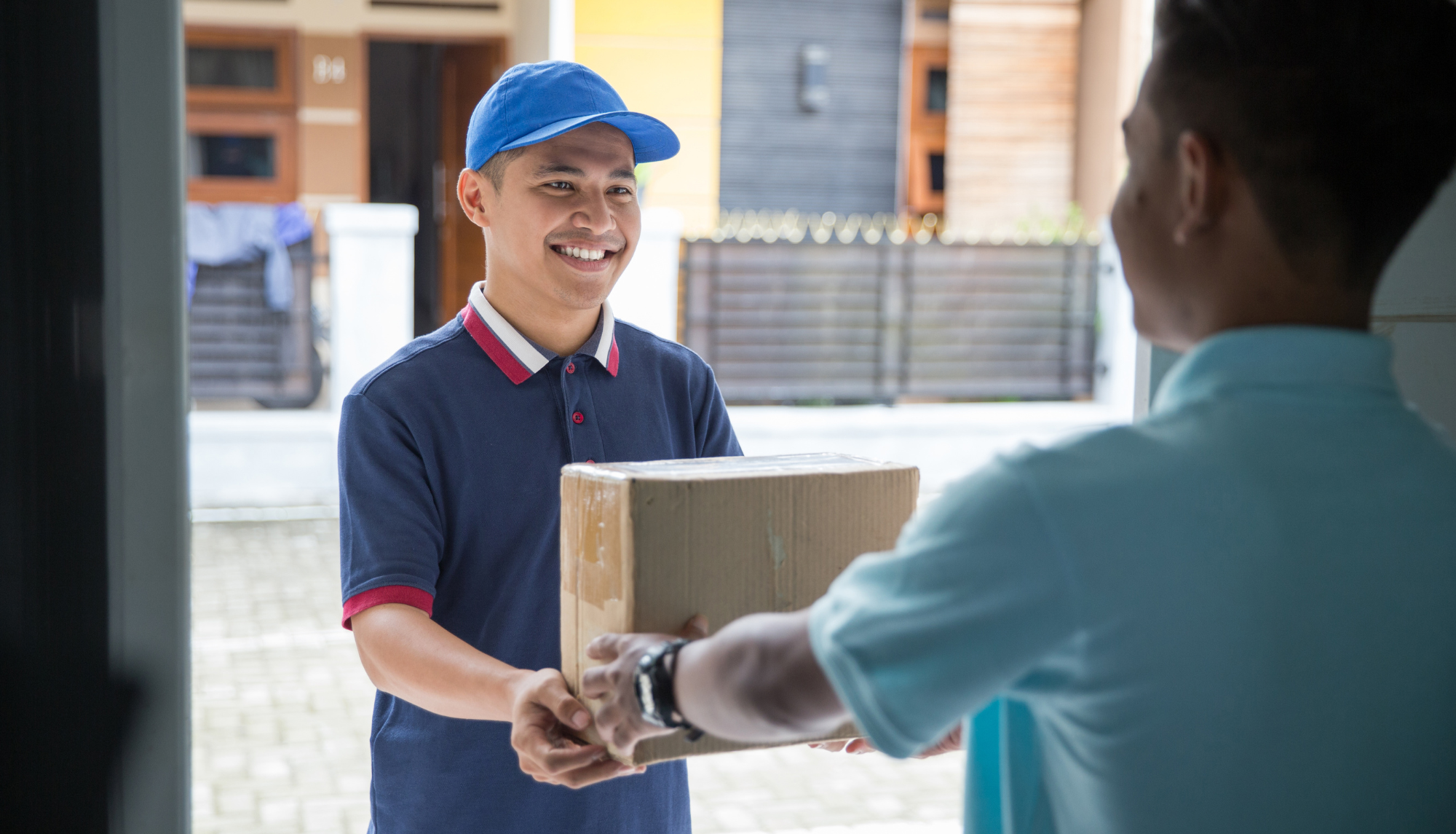 delivery guy handing a package to a guy